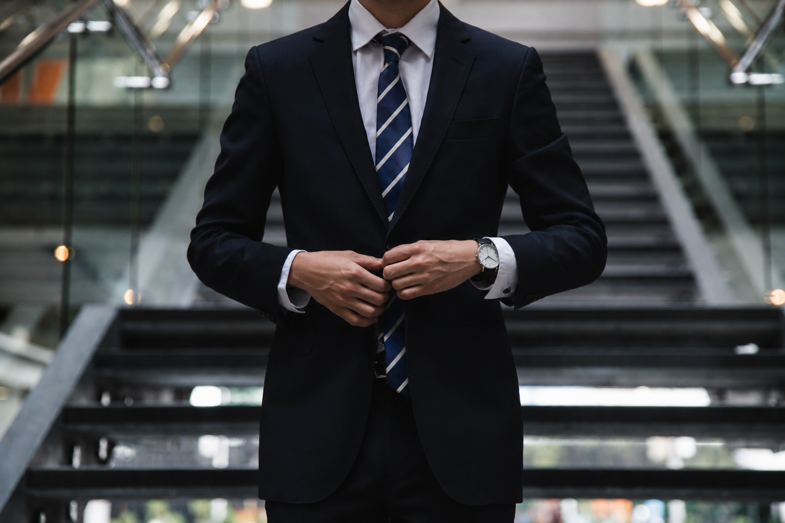 An executive leader in a suit preparing for his meeting with Deepklar's, Alen.